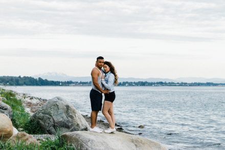 Couple is standing on a rock, hugging