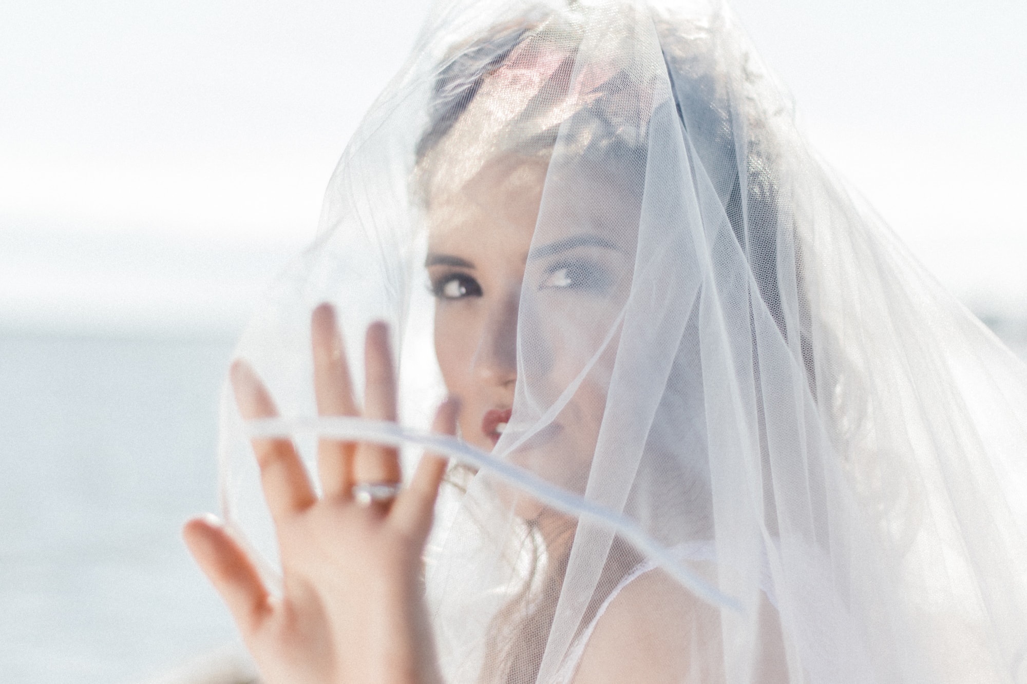 Portrait of a bride touching her veil
